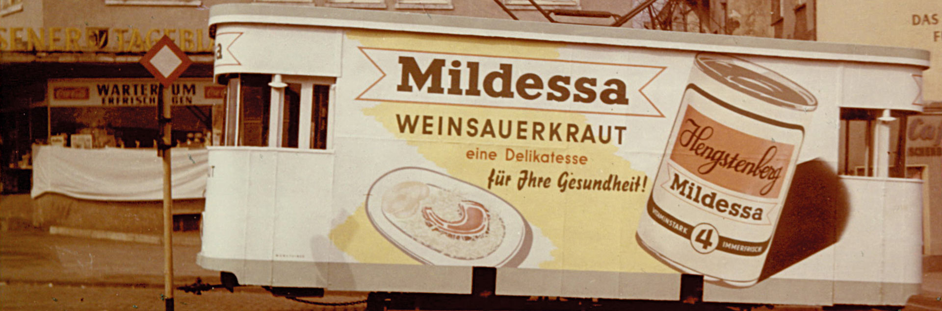 A train with a advertisement of Mildessa Wine Sauerkraut.