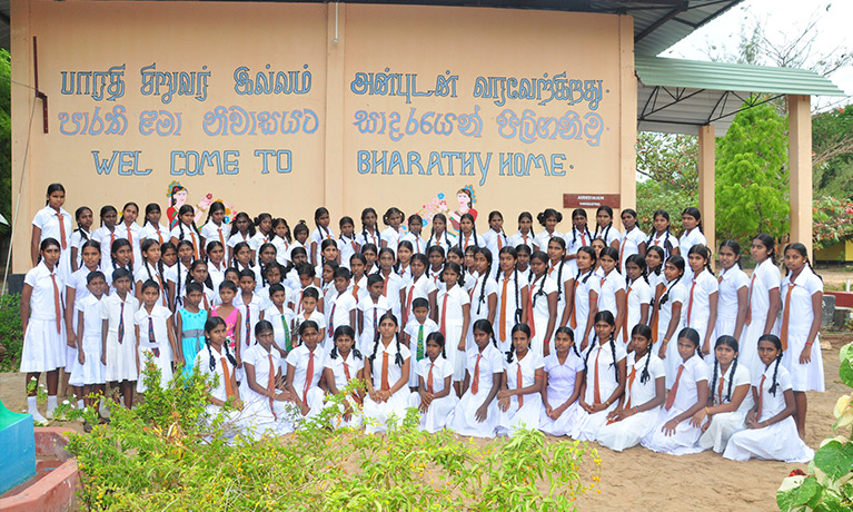 A group of orphans dressed in white.