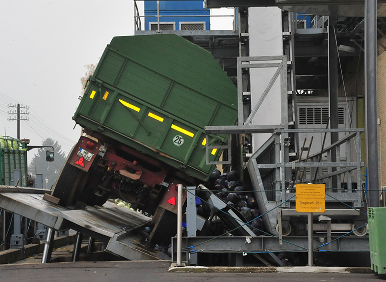 A tractor standing on a unloading ramp.