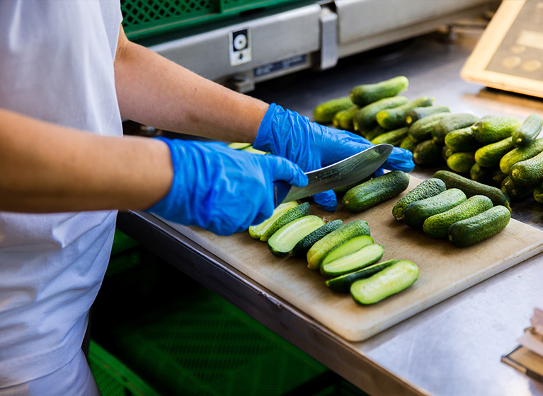 A person controlling some gherkins.