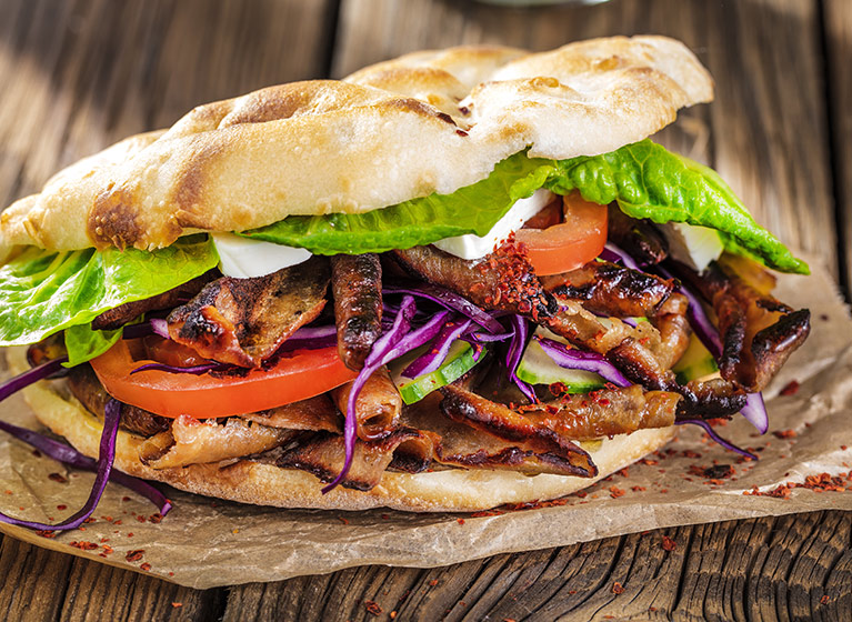 A kebab kepab on a wooden board.