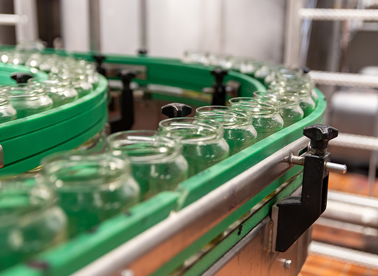 Some empty red cabbage glasses on a machine.