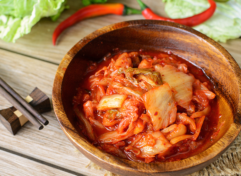 A wooden bowl with Korean Kimchi.