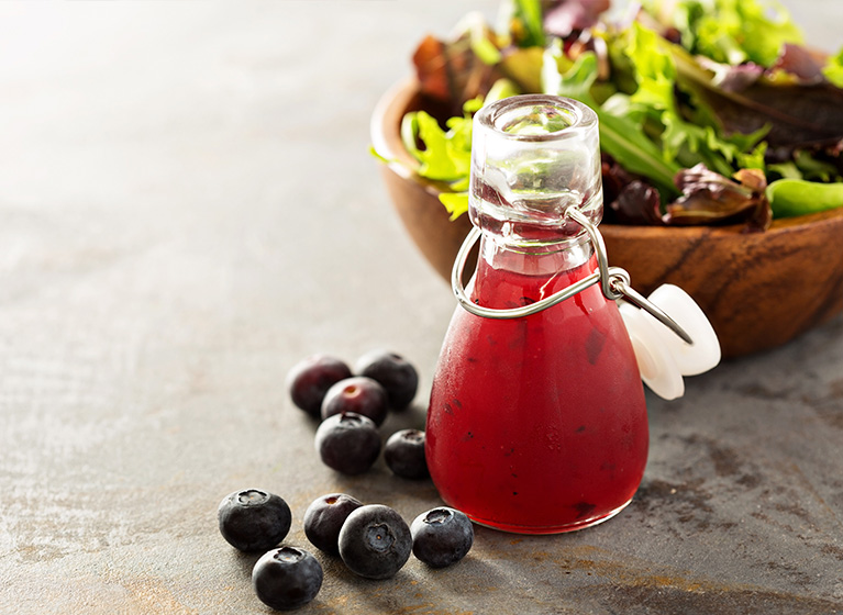 A bottle with a red fruit vinegar.